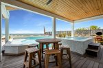Bar-height poolside dining table with seating for 5