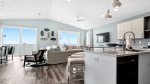 Main floor living/dining/kitchen area with beach views and walkout balcony