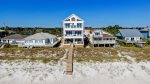 Back view of home with private beach walkover