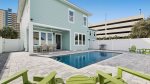 Private outdoor pool and lounge area with outdoor dining table