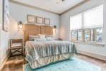 King bedroom, tv and attached bathroom.  Located on lower level of home.