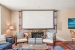 Living room with lowered TV screen at Oak Street House