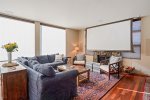 Living room with lowered TV screen at Oak Street House