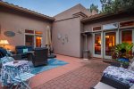 A covered outdoor seating area links the Casita with the main home