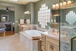 with a large soaking tub and beautiful glass shower