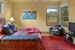 There is a queen size bed and a flat screen TV