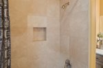 There is a walk-in shower and soaking tub
