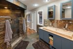 The ensuite bathroom has a custom double vanity and walk-in shower
