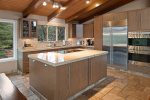 The kitchen features granite counters, high end appliances and modern kitchen essentials