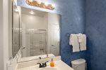 Hall access guest bathroom with a shower/ bath combo just outside the guest bedroom