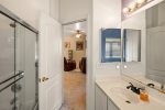 Hall access guest bathroom with a shower/ bath combo just outside the guest bedroom