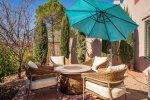 Soak up the sun, but keep cool with wide umbrella on the lovely back patio