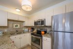 Lovely, granite counter tops, tasteful beachy decor, ice maker in the freezer