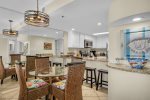 The kitchen is open and well stocked with a dishwasher, microwave, coffee pot, and more