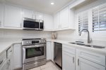 Well stocked kitchen with new stainless steel appliances.