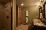 Downstairs, granite countertop, double vanity, tiled shower