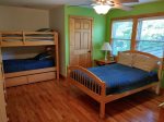 The full bedroom upstairs includes a full bed and bunk beds with trundle