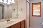 The hallway bath has a vanity sink with ample drawer space.