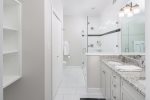 spacious bath with tile shower, double sinks, granite
