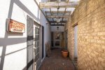 walk down alley to the right of building , turn left, elevator door ahead