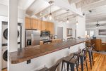 great kitchen with bar seating as well as dining table