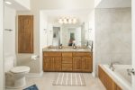 master bath with spa tub and separate shower, tile floors