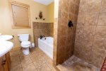 Ensuite master bathroom with tile shower and soaking tub