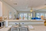 The view from the kitchen is beachy and tropical.