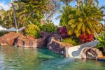 Pool with a Slide and a Beach