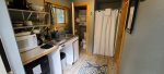 Kitchenette with two burners and a mini fridge along with the bathroom.