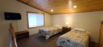 The open loft has a TV and two twin beds.