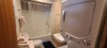 Full bathroom with shower/tub with a washer and dryer