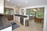 Kitchen with granite counter tops & stainless steel appliances.