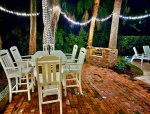 Brick Patio, Deck Seating, & Fire Pit Illuminated for evening meals.