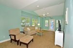 Second floor Living Room with ceiling fan & access to balcony.