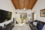 Living Room with Flat Screened TV & Vaulted Wood Ceiling