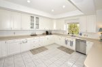 Kitchen with tray ceiling & recessed lighting.