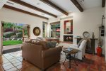 Formal Living Room has Gas Fireplace, Desk and Opens to Patio with Chaise Lounges and Mountain View