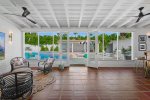 Sunroom Overlooking Pool Area Features Wet Bar and Seating Area