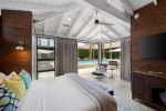 Master Bedroom One Features King Bed, 55``TV, En suite Bath, Sliding Glass Door to Backyard