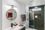 Guest Bathroom Features Walk-In Shower With Floor-To-Ceiling Tile