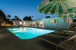 Pool and Furnished Covered Patio At Night