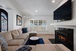 Family Room Features 75 Inch TV & Fireplace