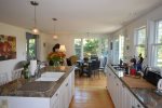 Large open kitchen with island, flat top stove, and dining area