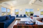 Living room with views out sliding deck doors of Fisher Beach 