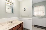 Full bathroom with a stand up shower and laundry 
