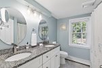 Full bathroom with a double vanity, tub, and shower