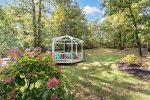 The gazebo is a unique feature that stands out against the lovely landscaping