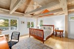 Primary bedroom with a queen bed and views of the backyard