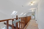 Upstairs walkway leading to the bedrooms overlooks the living room